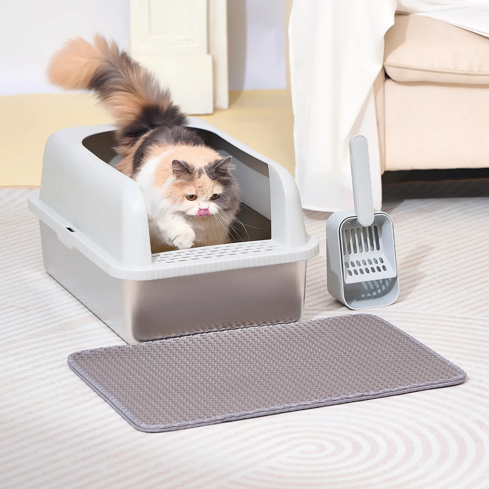 A cat steps out of the steel litter box